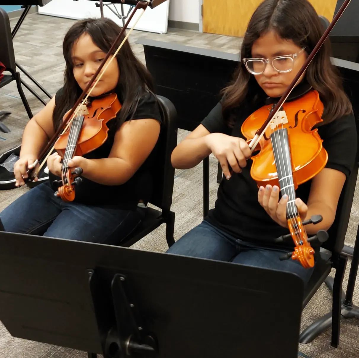 young girls playing violins