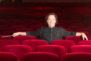 Conductor Bohuslav Rattay sitting in seats at the Plaza Theater